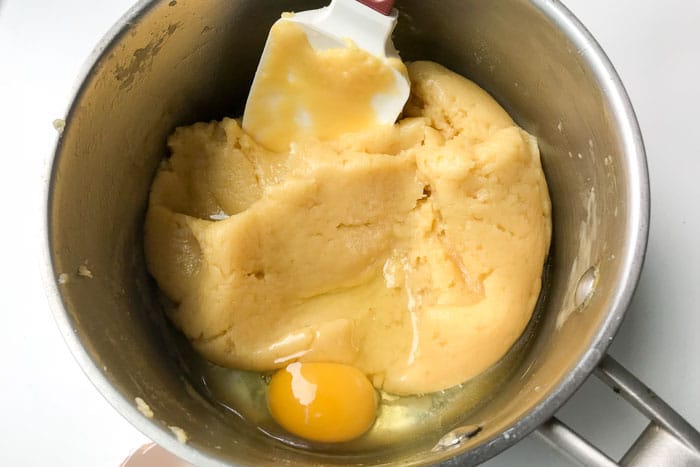 Mixing eggs into choux pastry