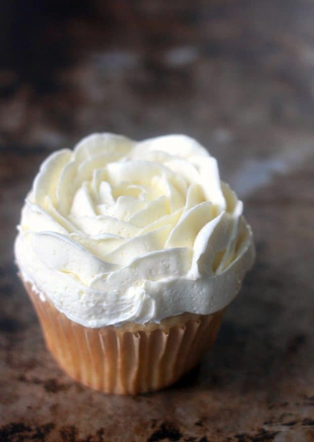 A decorated cupcake with soft buttercream
