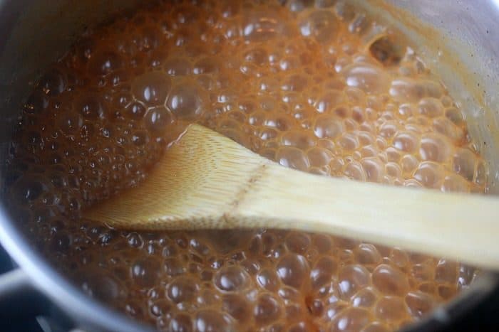 Cream being cooked with caramelized sugar to thicken for caramel sauce